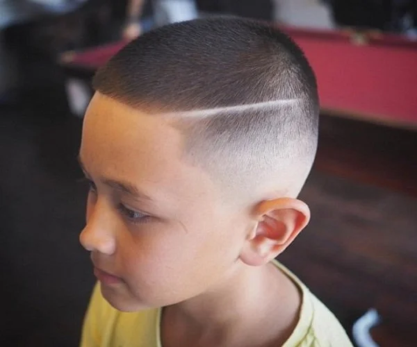 Bé trai với kiểu tóc cạo fade kẻ vạch
